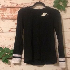 A black shirt with white stripes on the sleeves.